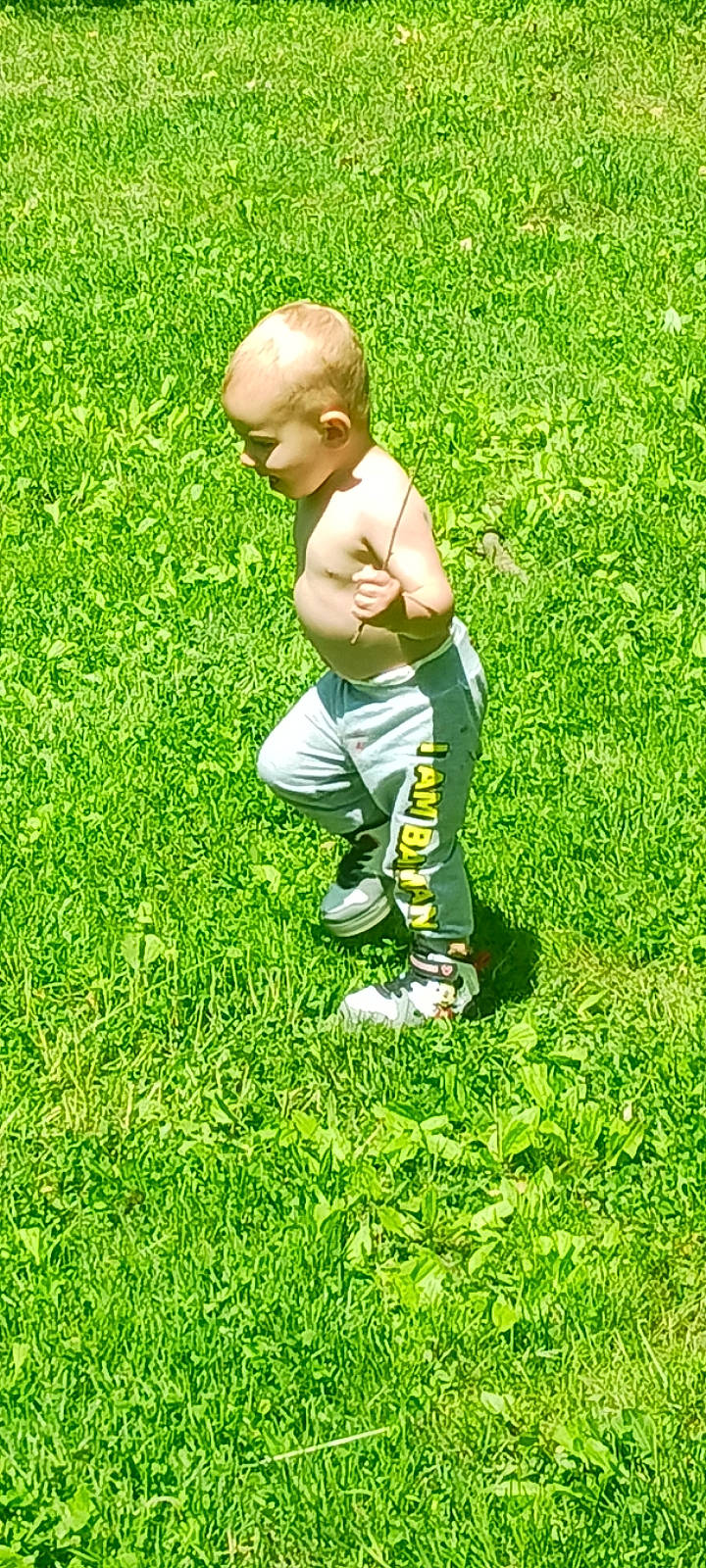 Aiden is registered to the contest to win money with this photo: baby, child, flooring, foot, gesture, grass, grass_family, grassland, groundcover, happy, human_leg, knee, lawn, leg, leisure, meadow, people_in_nature, person, shoe, thumb