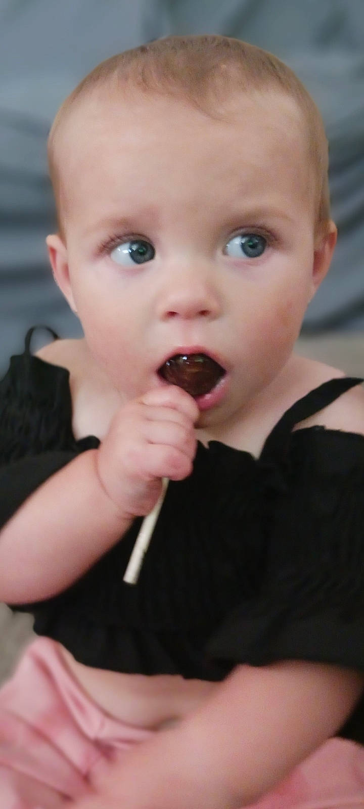 Hadley is registered to the contest to win money with this photo: baby, baby_toddler_clothing, biting, cheek, ear, eating, eyelash, finger, food_craving, fun, gesture, happy, lip, mouth, nail, nose, person, skin, surprise, sweetness