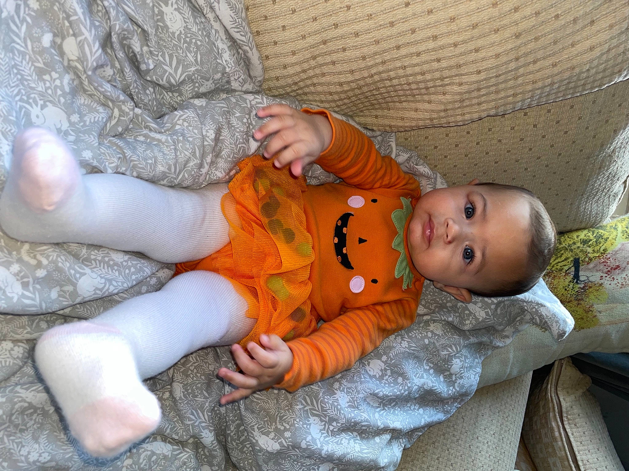 Nova-saige is registered to the contest to win money with this photo: baby, baby_products, baby_toddler_clothing, child, comfort, couch, grass, infant_bed, linens, nail, orange, pattern, person, product, room, sitting, skin, sleep, toddler, wood