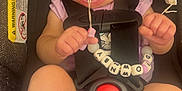 Davinia joined the competition — help win amazing prizes! accessory, baby, beads, car_seat, child, closeup, clothing, cute, headband, indoor, infant, pacifier, person, pink, safety, seatbelt, sitting, socks, toy, young_child