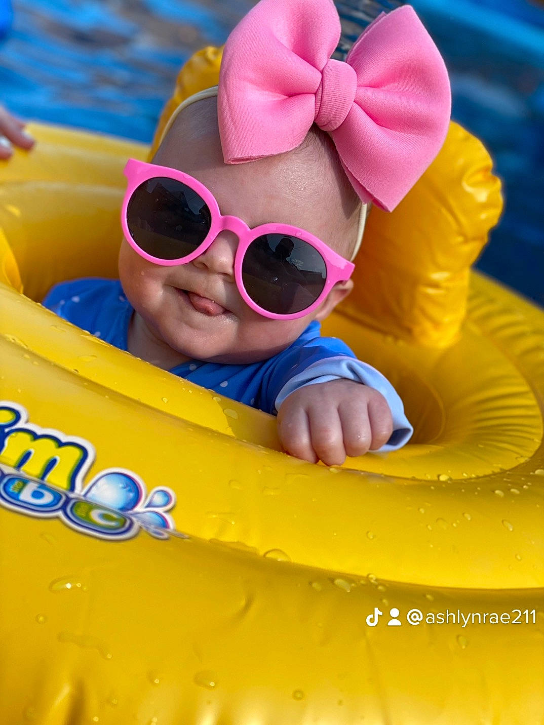 Breelyn is registered to the contest to win money with this photo: baby, baby_toddler_clothing, blue, child, eyewear, fun, games, goggles, happy, inflatable, leisure, lifejacket, person, personal_protective_equipment, play, recreation, sand, sunglasses, toddler, vision_care