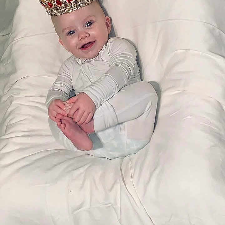 Paxton joined the competition — help win amazing prizes! accessories, baby, babylaughing, blanket, clothing, crown, face, happy, head, jewelry, lady, person, photography, portrait, sitting, sleeve, smile