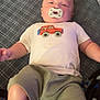 Xavior joined the competition — help win amazing prizes! baby, pacifier, shirt, car_design, shorts, blanket, pattern, infant, child, lying_down, indoors, cute, young, relaxed, clothing, person, skin, head, legs, baby_boy