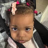 Harmony joined the competition — help win amazing prizes! child, baby, stroller, hair_bow, pink_hair_ties, face, eyes, clothing, seatbelt, indoor, portrait, curious, closeup, infant, person, cute, young_child, expression, baby_girl, seated
