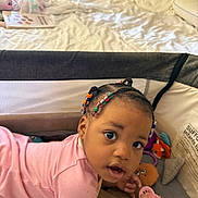 Harmony joined the competition — help win amazing prizes! baby, child, playpen, pacifier, bed, braids, beads, toy, indoor, curious, pink_clothing, infant, person, cute, looking, head, face, hand, home, toddler