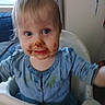 Lilly joined the competition — help win amazing prizes! toddler, child, high_chair, chocolate, messy, face_paint, blue_clothing, indoor, smile, happy, food, baby, cute, mess, feeding_time, person, young_child, dining, kitchen, playful