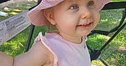 Lilly joined the competition — help win amazing prizes! toddler, child, hat, pink, smile, outdoor, sunlight, stroller, mesh, cartoon, clothing, face, happy, person, baby, headwear, summer, playtime, cute, blue_eyes