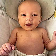 Payton is registered to the contest to win money with this photo: baby, infant, smile, face, skin, hand, seatbelt, cushion, blanket, indoor, child, person, head, torso, comfort, baby_seat, cute, young, human, newborn