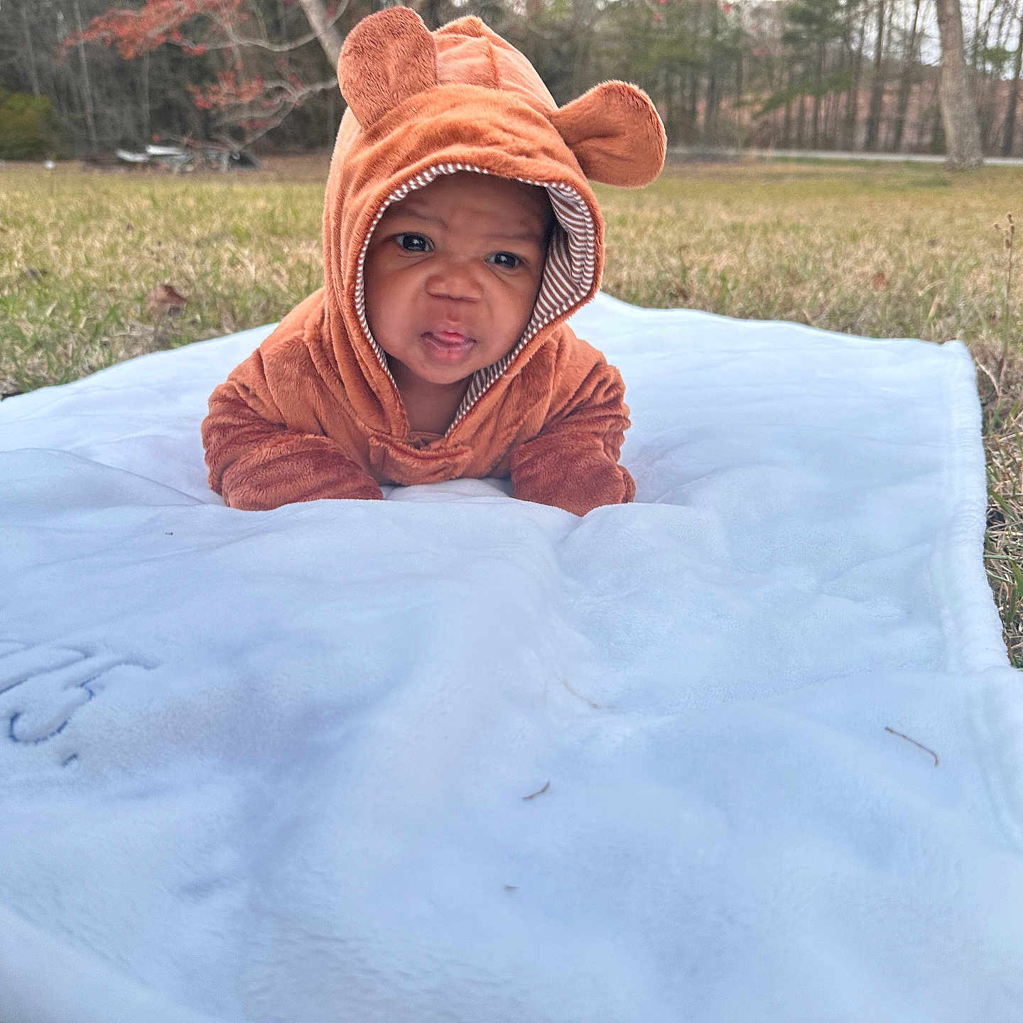 Kamazi joined the competition — help win amazing prizes! baby, blanket, clothing, face, fashion, grass, happy, hat, head, hood, hoodie, knitwear, person, photography, plant, portrait, smile, sweater, sweatshirt, towel