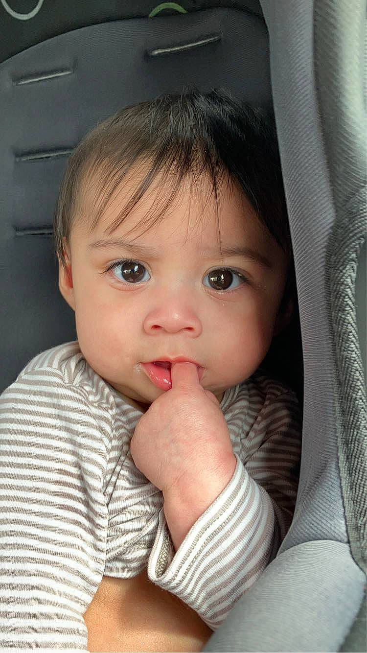 Sakoni is registered to the contest to win money with this photo: arm, baby, baby_toddler_clothing, cheek, chin, close_up, comfort, eyebrow, eyelash, finger, gesture, hairstyle, hand, iris, lip, nose, person, skin, sleeve, thumb