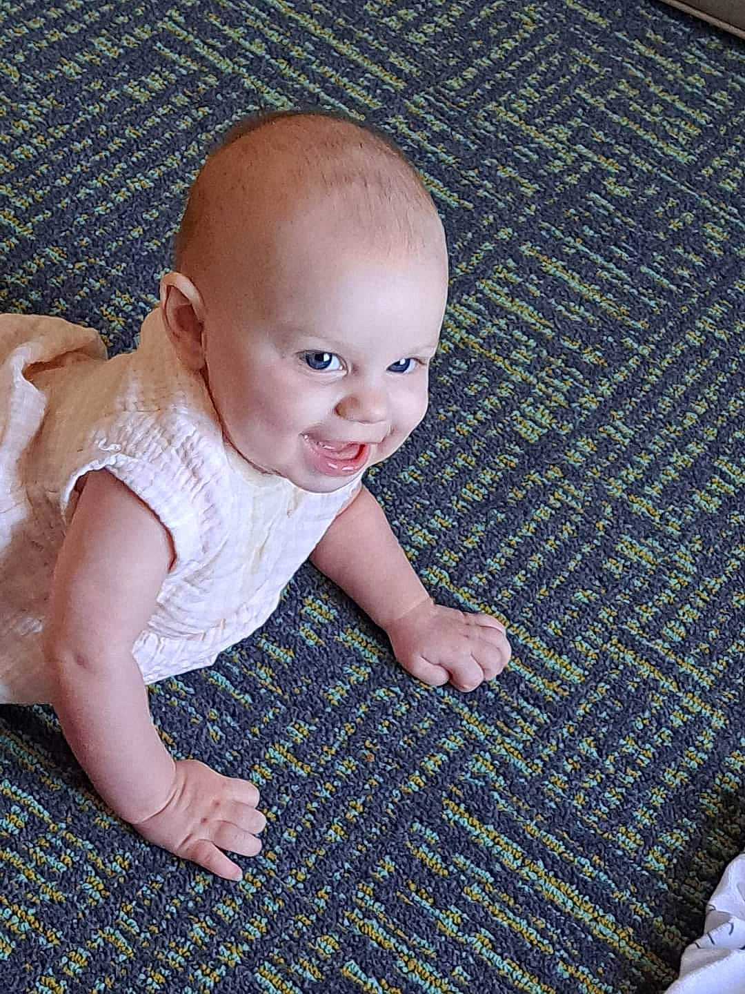 Riley joined the competition — help win amazing prizes! baby, baby_toddler_clothing, cheek, child, comfort, electric_blue, eye, finger, floor, flooring, grass, happy, iris, pattern, people_in_nature, person, sitting, skin, smile, toddler