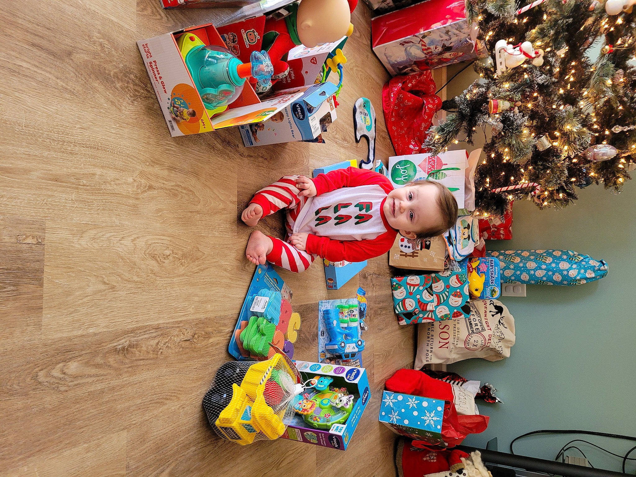 Colson is registered to the contest to win money with this photo: carmine, child, christmas_decoration, christmas_ornament, christmas_tree, event, fashion_accessory, font, fun, happy, hat, holiday, holiday_ornament, joy, ornament, party_supply, pattern, person, plastic, play