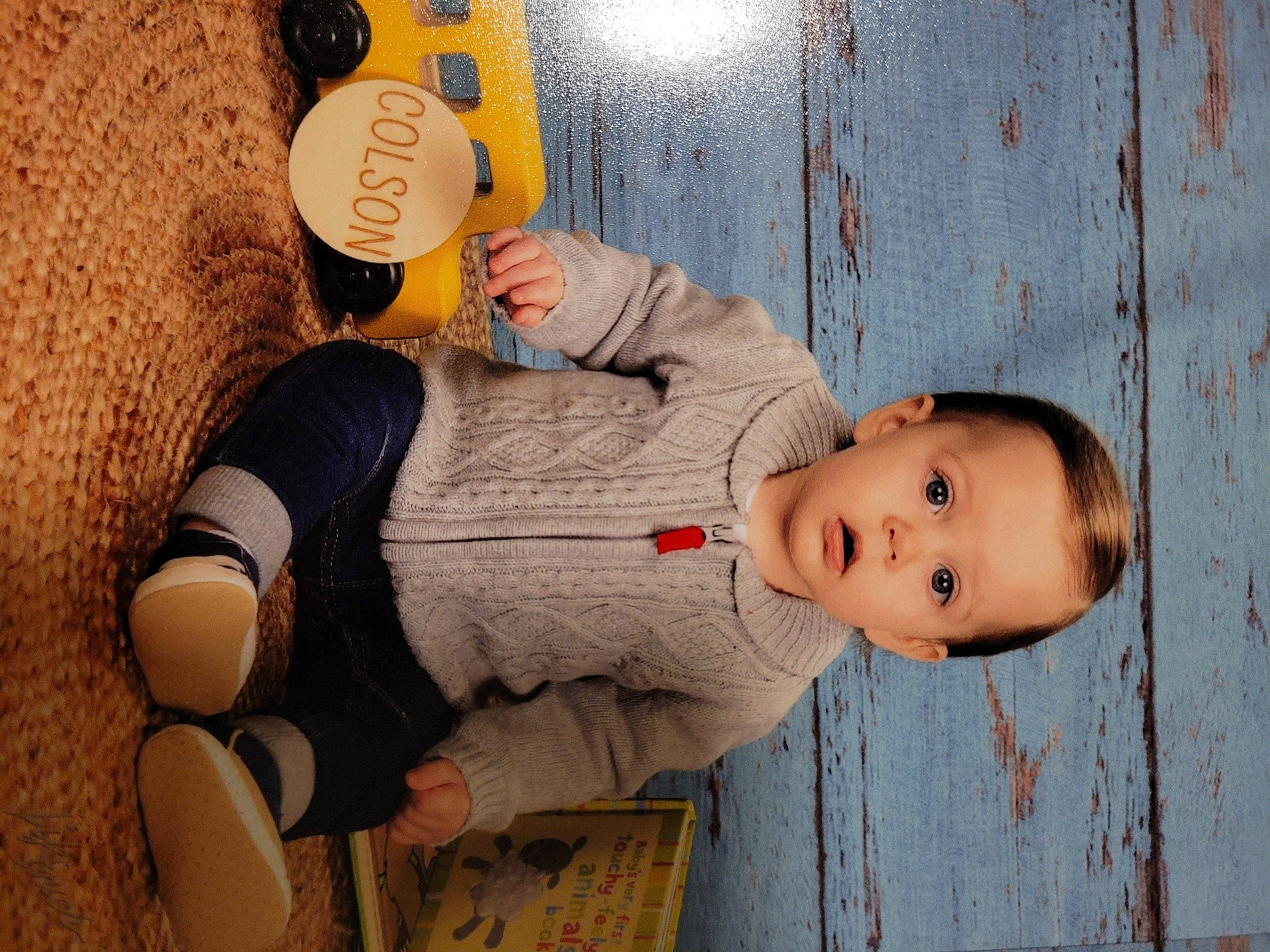 Colson joined the competition — help win amazing prizes! cheek, child, elbow, fashion_accessory, fun, happy, hat, headgear, human_leg, pattern, person, personal_protective_equipment, sitting, smile, thigh, toddler, wood