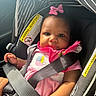 baby, car_seat, child, infant, pink_bow, pink_clothing, seatbelt, strapped_in, car_interior, warning_label, striped_canopy, adorable, cute, portrait, young_child, safety, close_up, person, indoor, seat