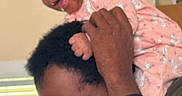Alana is registered to the contest to win money with this photo: adult, baby, child, clothing, face, family, hair, happy, head, headband, holding, indoor, interaction, person, pink, playful, shoulders, skin, smiling, window