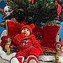 Emily joined the competition — help win amazing prizes! baby, child, christmas_tree, red_clothing, hat, booties, holiday, decorations, ornate_chair, festive, indoors, floor, pom_pom, cute, seasonal, celebration, smiling, winter_wear, home, festivity