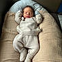 baby, blanket, child, clothing, cozy, cream_color, cushion, cute, head, indoors, infant, knitwear, newborn, pacifier, person, relaxed, resting, sleeping, small, soft