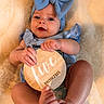 Magnolia is registered to the contest to win money with this photo: baby, infant, blue_bow, headband, blue_clothing, wooden_plaque, five_months, drool, blanket, soft_texture, cute, lying_down, hands, feet, skin, portrait, smile, indoor, person, child