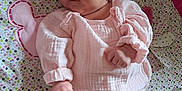 Louéna participe au concours pour gagner de l'argent avec cette photo : baby, infant, pink_clothing, headband, patterned_blanket, lying_down, cute, small_hands, soft_fabric, indoors, child, newborn, cozy, sleepwear, headwear, person, portrait, colorful, comfort, resting