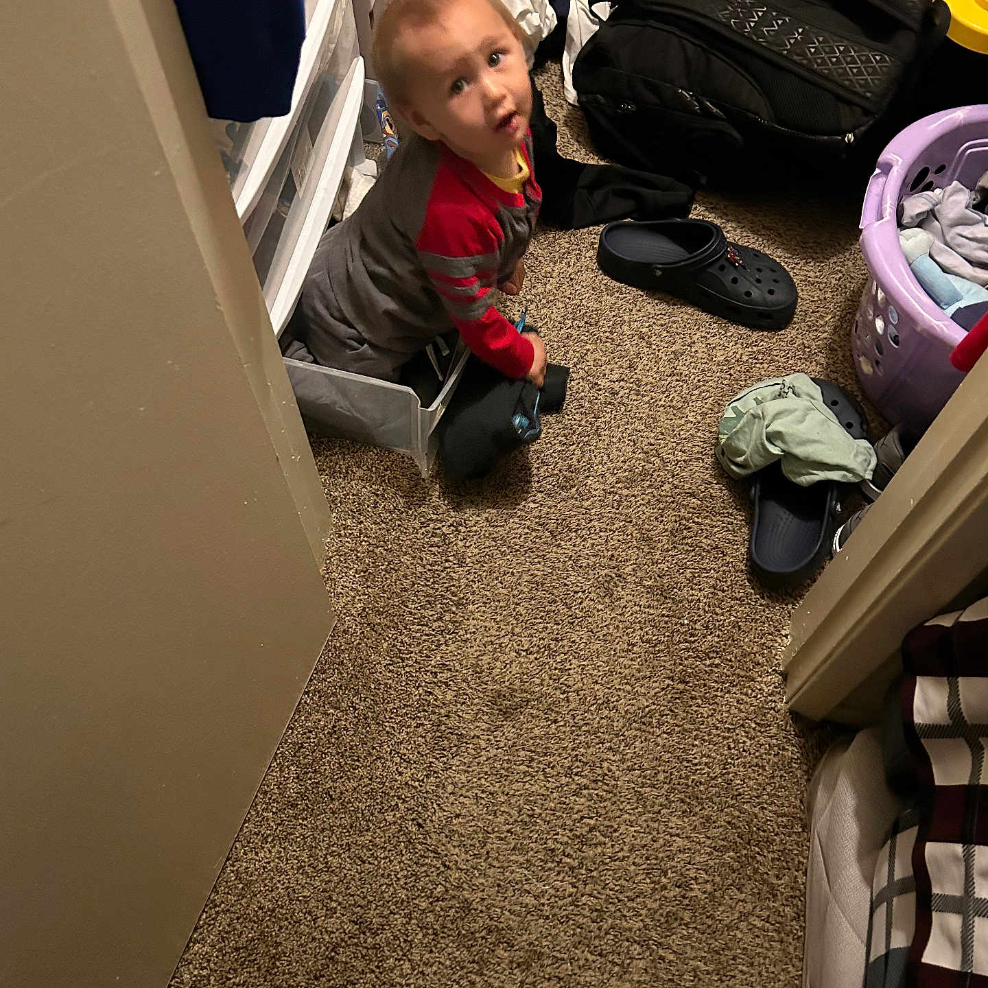 Jacob Corona joined the competition — help win amazing prizes! backpack, carpet, carpeted_floor, child, clothing, curious, drawer, face, household, indoor, laundry_basket, messy, person, playful, room, shoe, sitting, toddler, toy, young_child