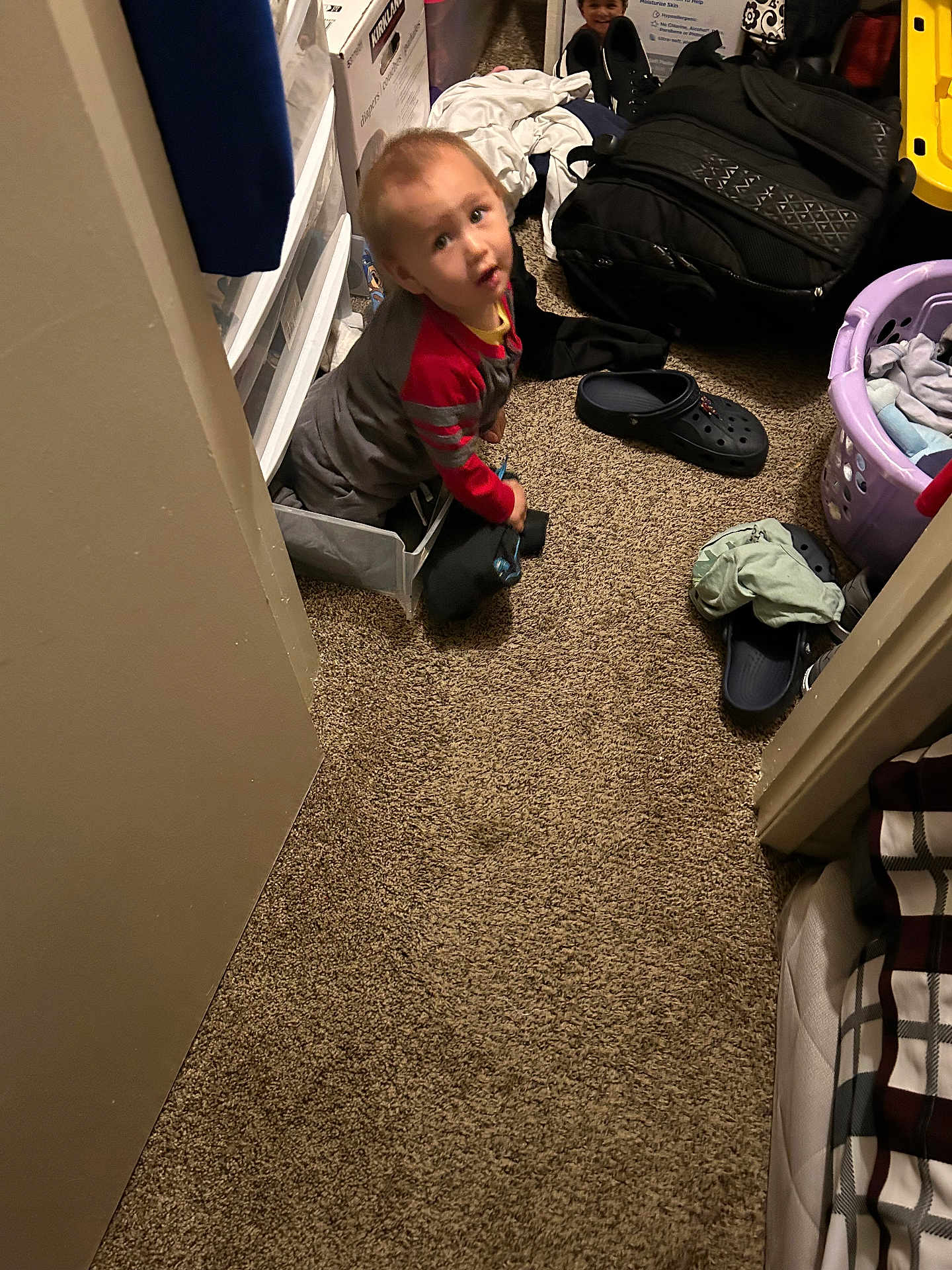 Jacob Corona joined the competition — help win amazing prizes! toddler, child, drawer, carpet, laundry_basket, clothing, shoe, indoor, room, curious, carpeted_floor, household, messy, playful, person, face, sitting, young_child, toy, backpack