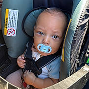 Kairo is registered to the contest to win money with this photo: baby, pacifier, car_seat, child, infant, seatbelt, safety, car, straps, child_safety, toddler, baby_clothing, cute, indoors, portrait, seat, young_child, head_support, car_interior, baby_face