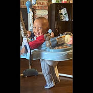 Kairo joined the competition — help win amazing prizes! activity_center, baby, brick_wall, child, face, floor, furniture, happy, home, indoor, legs, person, play, red_shirt, shelf, sitting, smiling, socks, toddler, toy