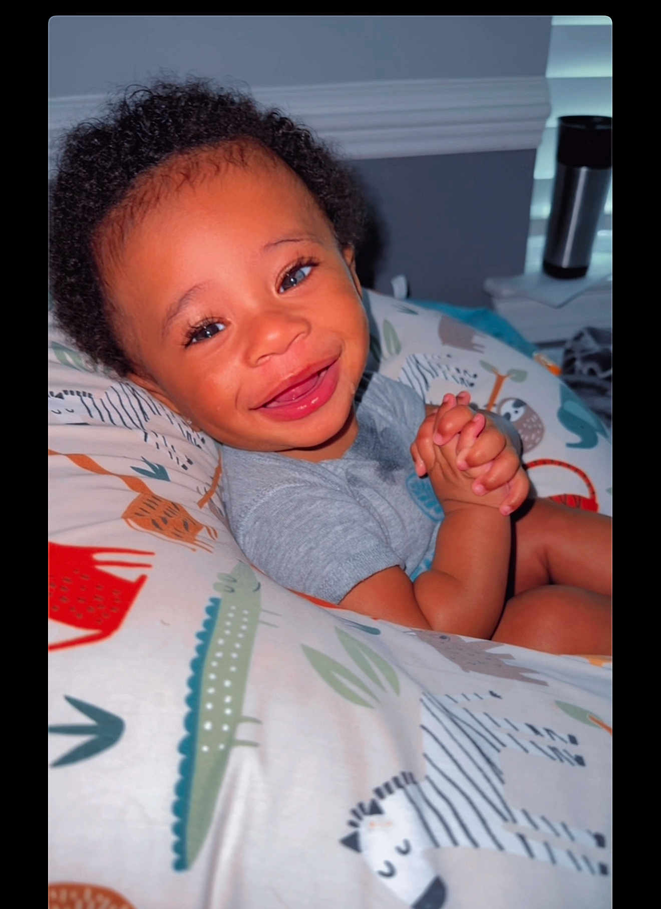 Nasier is registered to the contest to win money with this photo: animal_print, baby, bright, child, clothing, colorful, cozy, curly_hair, cushion, cute, expression, face, hands, happy, indoor, person, portrait, smiling, toddler, young