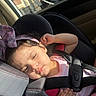 toddler, child, car_seat, seatbelt, bow, headband, sleeping, sunlight, car_interior, seat, safety, relaxed, young_child, portrait, baby, clothing, resting, hand, pink, cute