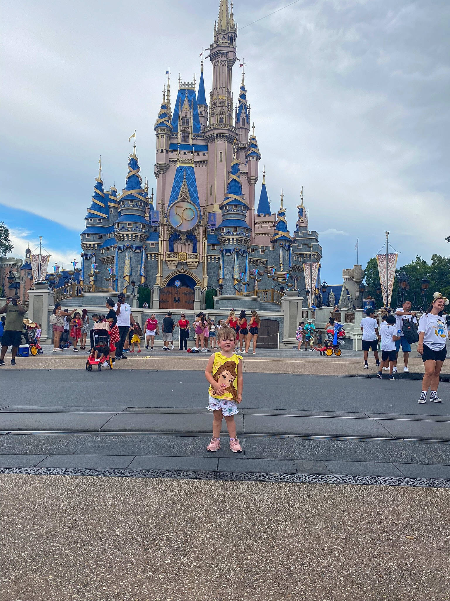Kari is registered to the contest to win money with this photo: building, city, cloud, event, facade, finial, fun, joy, leisure, nonbuilding_structure, pedestrian, person, recreation, shorts, sky, spire, street, tourism, travel, turret