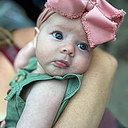 Maesyn joined the competition — help win amazing prizes! baby, infant, child, blue_eyes, pink_bow, headband, green_outfit, close_up, portrait, arm, holding, cute, skin, person, young_child, face, expression, soft_focus, outdoor, gentle