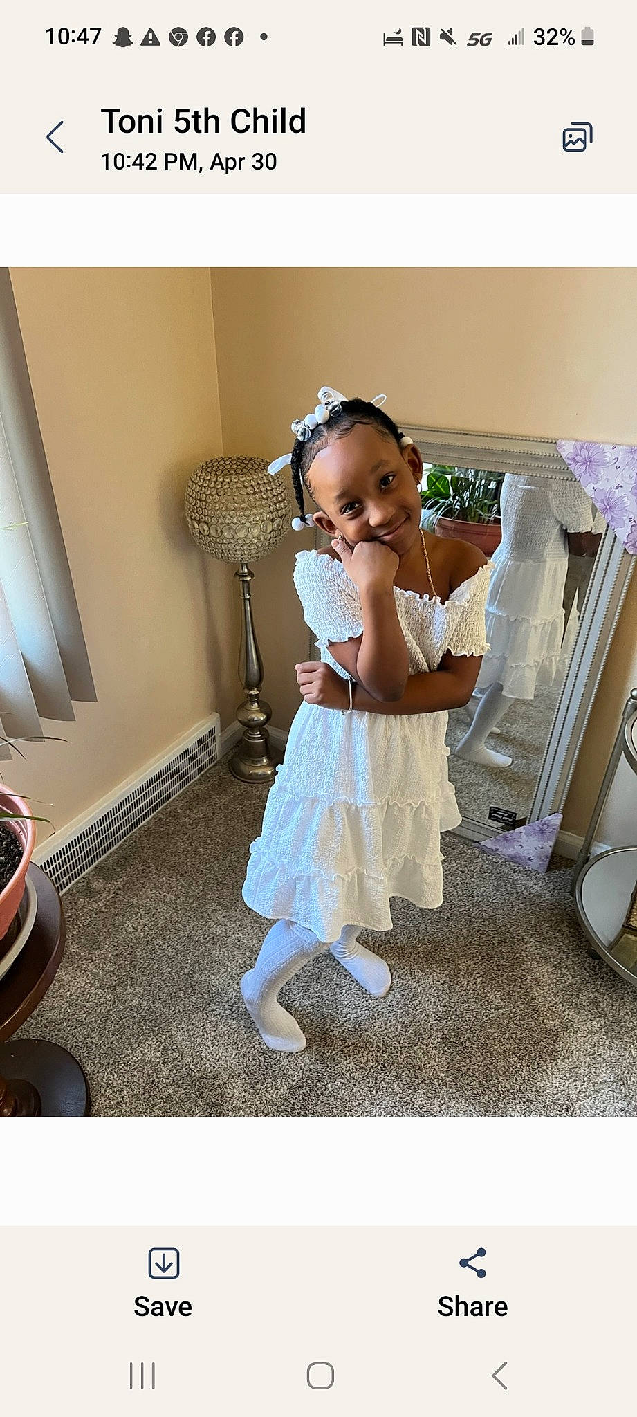 Rian is registered to the contest to win money with this photo: baby_toddler_clothing, child, day_dress, fashion_accessory, fashion_design, flooring, formal_wear, happy, hat, human_leg, joy, knee, lamp, pattern, person, room, sitting, sleeve, smile, toddler