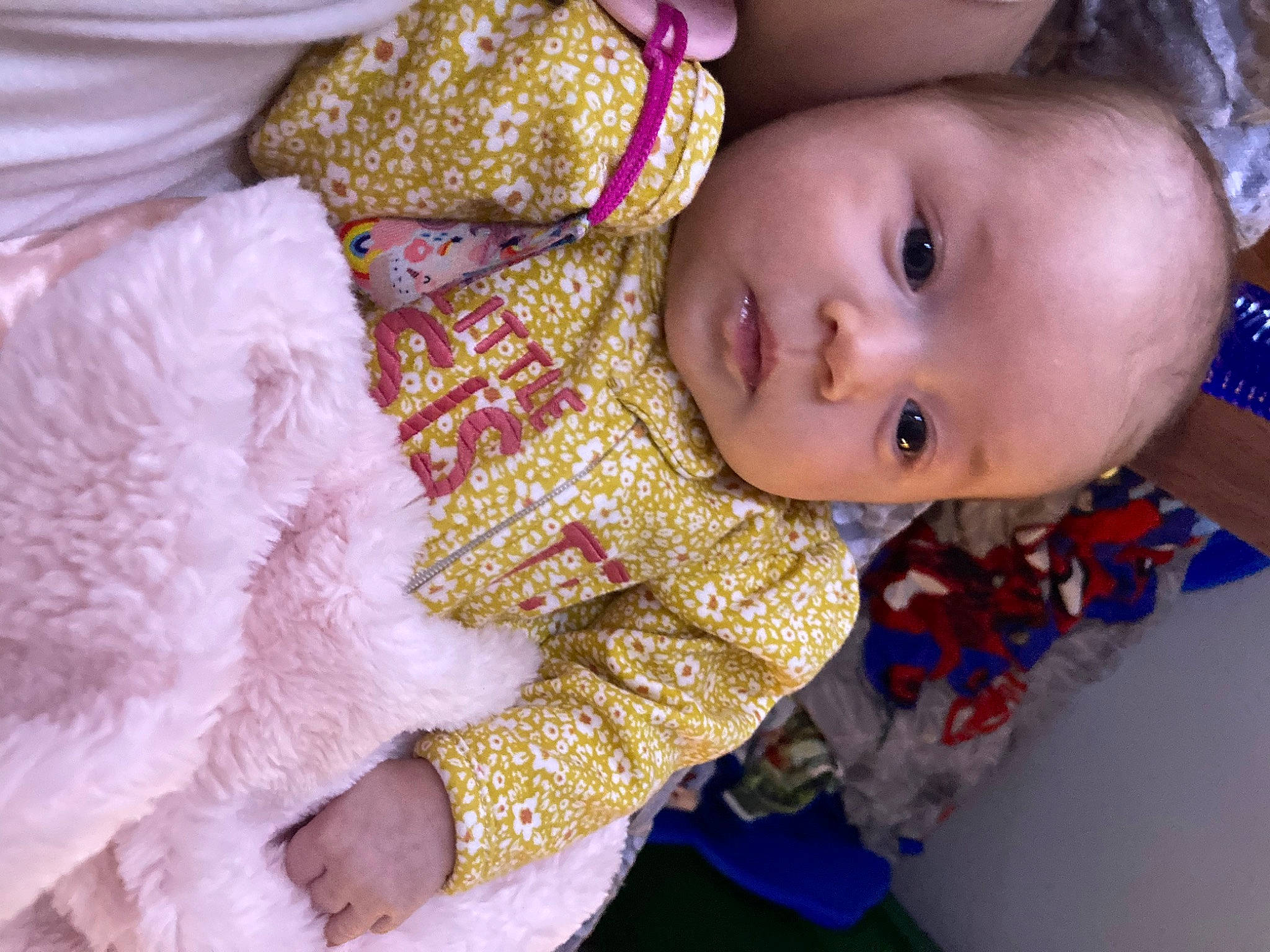 Kyra is registered to the contest to win money with this photo: baby, baby_toddler_clothing, cheek, child, dress, event, eye, face, happy, head, iris, linens, magenta, nose, pattern, person, pink, red, skin, sleeve