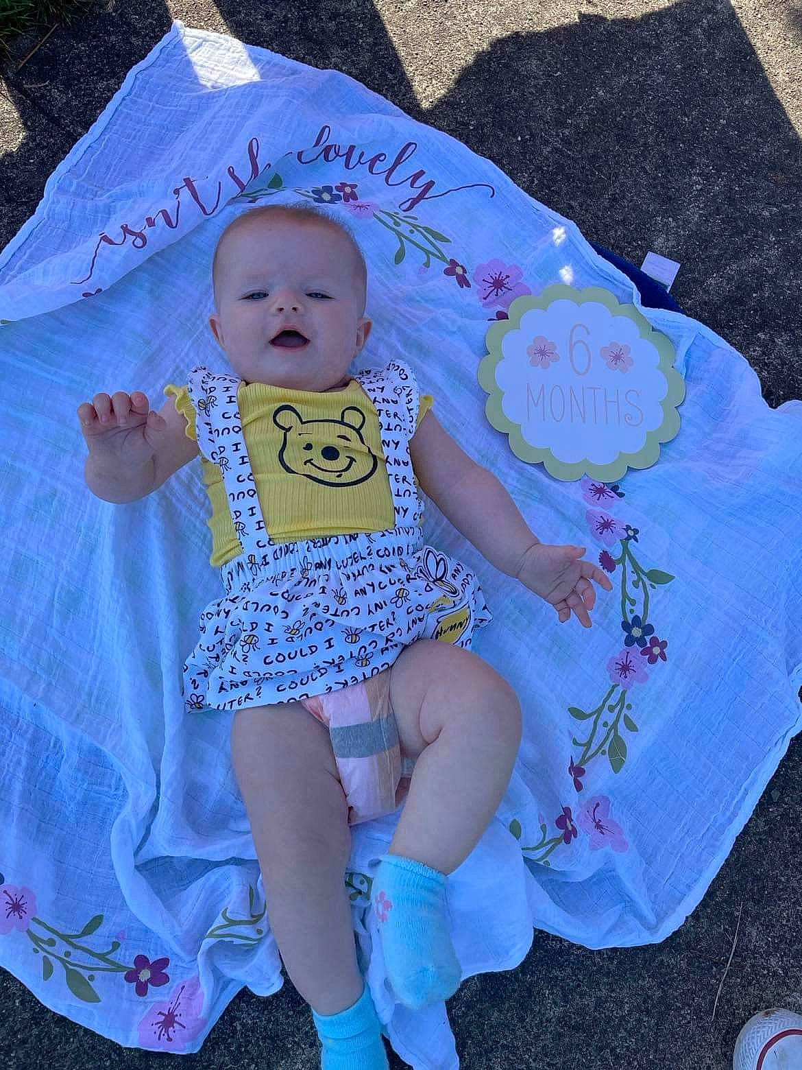 Kynzley is registered to the contest to win money with this photo: aqua, azure, baby, baby_products, baby_toddler_clothing, blue, child, doll, dress, electric_blue, happy, head, pattern, person, pink, product, purple, sitting, textile, toddler