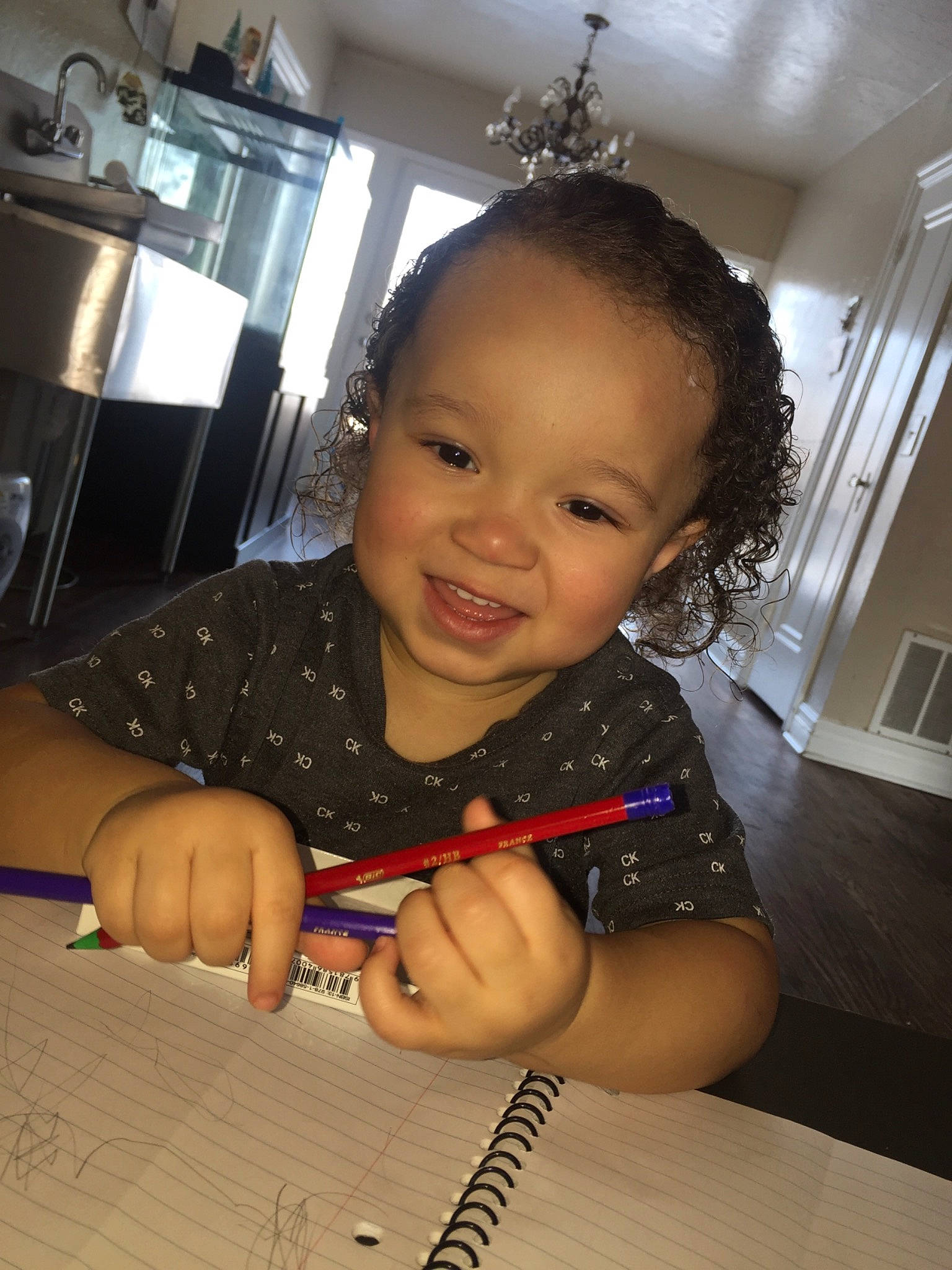 Kamarion is registered to the contest to win money with this photo: countertop, eyebrow, finger, hand, home_appliance, homework, joy, kitchen, kitchen_appliance, mouth, nail, office_supplies, pen, person, small_appliance, smile, stationery, thumb, toddler, tooth