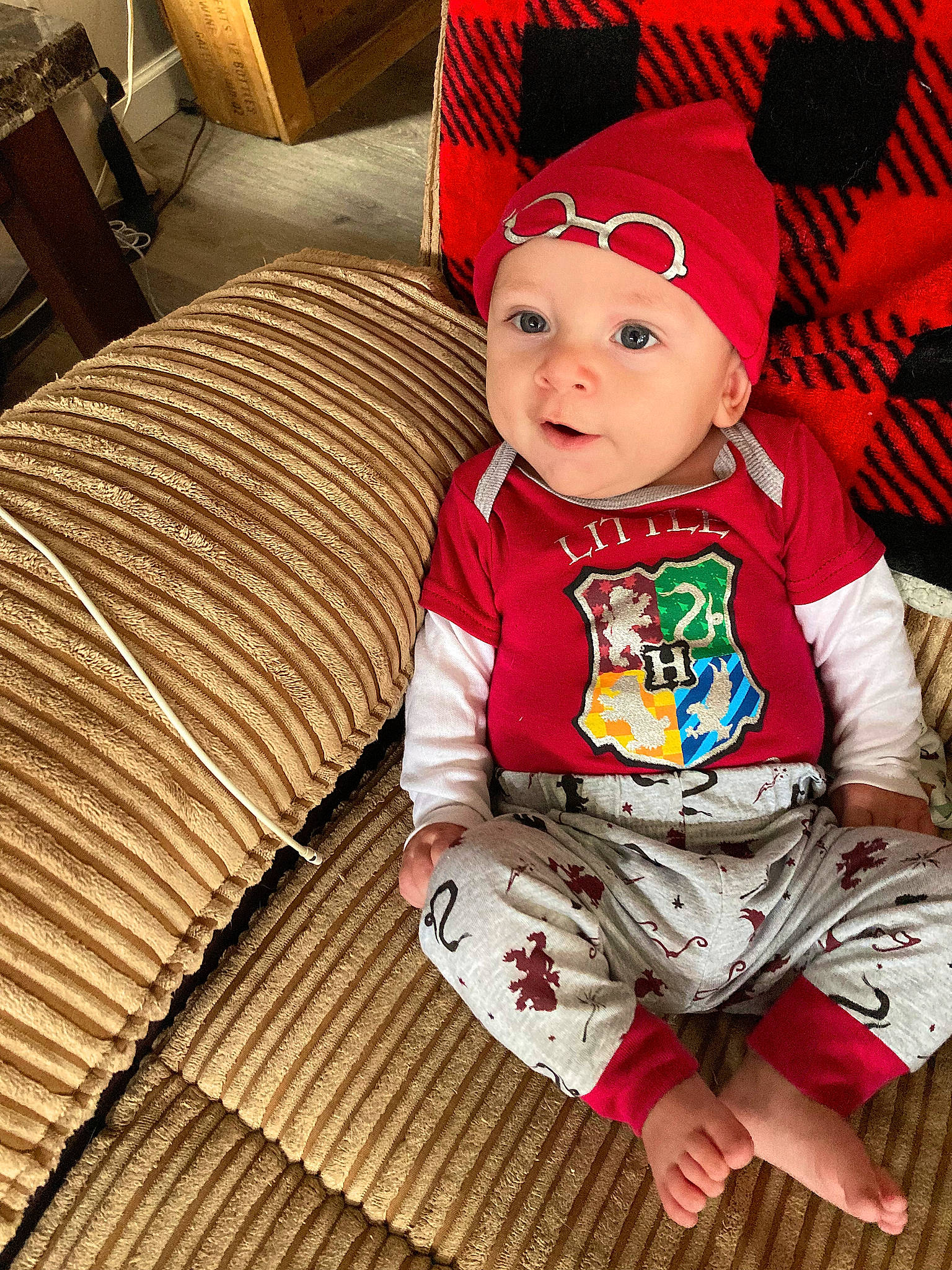 Jaxson is registered to the contest to win money with this photo: baby, baby_toddler_clothing, cap, child, comfort, costume_hat, eye, face, happy, hardwood, head, headgear, headwear, pattern, person, sitting, skin, sleeve, smile, textile