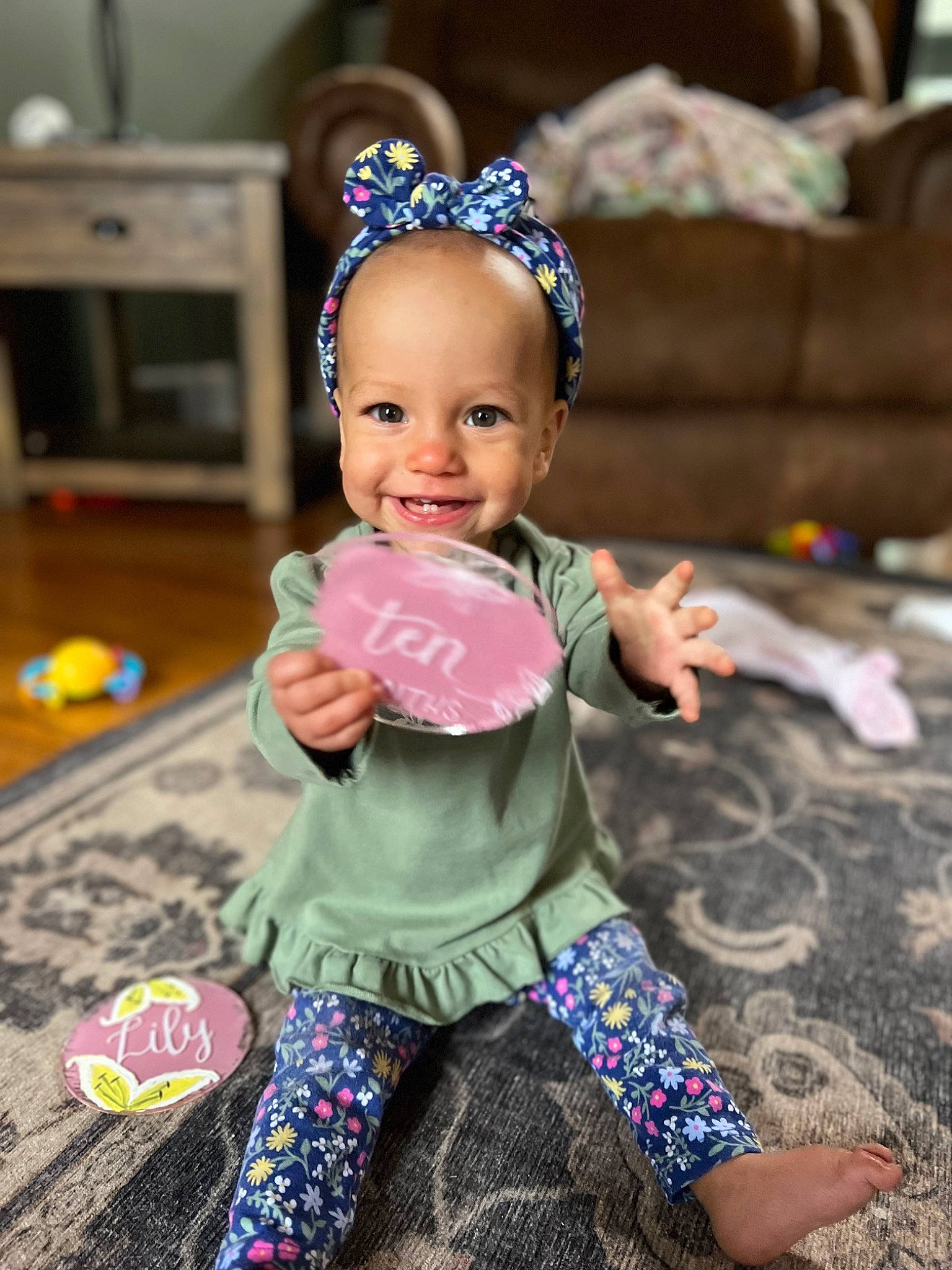 Liliana joined the competition — help win amazing prizes! baby, baby_toddler_clothing, baby_toys, blue, child, fashion_accessory, flooring, fun, happy, headgear, joy, leisure, party, party_supply, person, pink, play, purple, sitting, smile