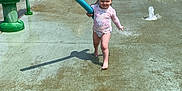 Paisley joined the competition — help win amazing prizes! toddler, child, water_park, splash_pad, water_fountain, pool_noodle, playground, outdoor, summer, fun, sunny, water_spray, footwearless, play, recreation, baseball_glove_sculpture, greenery, trees, water, happiness