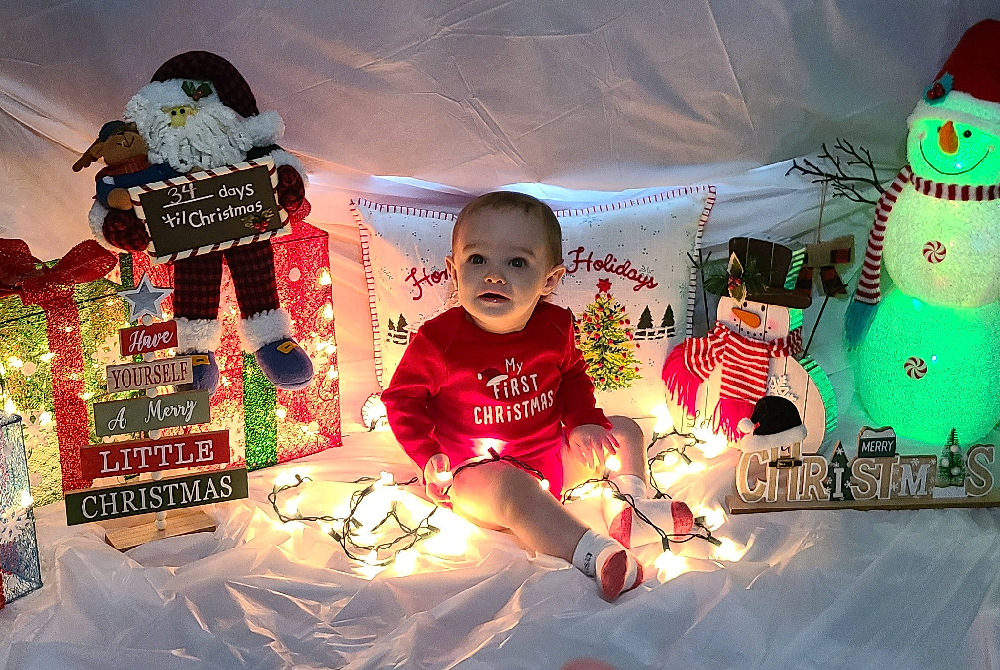 Lane Lovett is registered to the contest to win money with this photo: carmine, christmas, christmas_decoration, christmas_eve, christmas_ornament, doll, event, fictional_character, fun, happy, hat, holiday, leisure, light, lighting, ornament, person, toddler, toy, winter