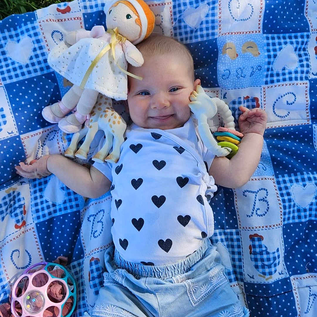 Lysandra participe au concours pour gagner de l'argent avec cette photo : baby, blanket, child, clothing, cute, doll, face, feet, grass, happy, infant, nature, outdoor, person, play, relax, shorts, smiling, summer, toy