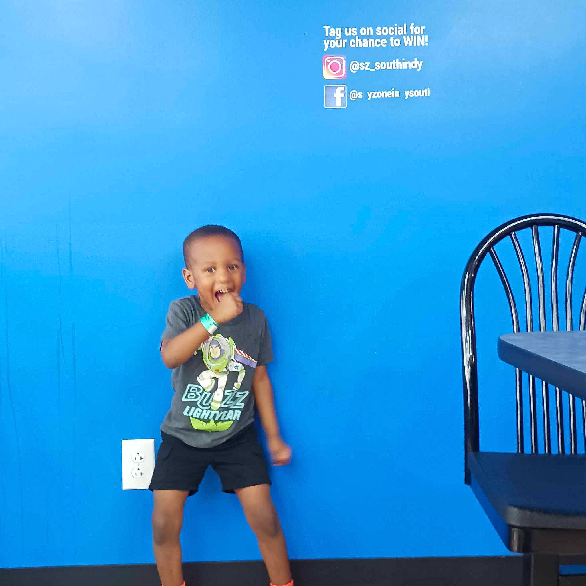 Jaxon is registered to the contest to win money with this photo: azure, baby_toddler_clothing, balance, blue, child, elbow, electric_blue, flooring, fun, happy, human_leg, knee, leisure, person, shorts, sitting, sleeve, standing, t_shirt, thigh