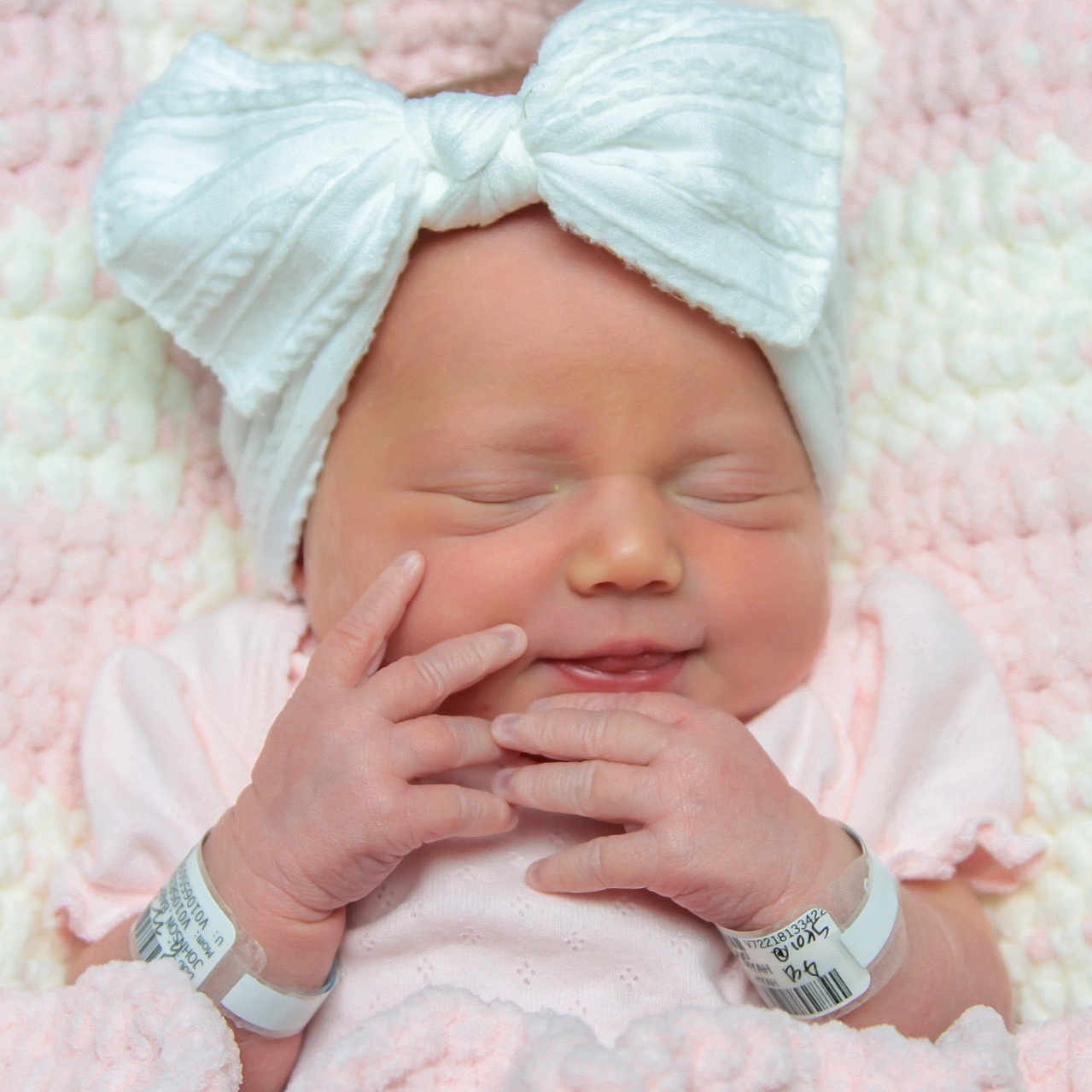 Sutty joined the competition — help win amazing prizes! baby, newborn, infant, white_bow, pink_blanket, soft_texture, sleeping, cute, child, portrait, hand_gesture, hospital_bracelet, peaceful, cozy, closeup, headwear, skin, resting, indoors, tiny_fingers