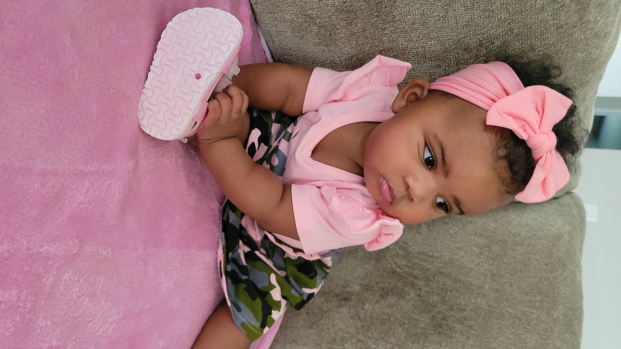 Ariella is registered to the contest to win money with this photo: baby, baby_products, baby_toddler_clothing, cap, cheek, child, comfort, eyelash, fashion_accessory, grass, hat, headgear, human_body, lip, magenta, nose, person, pink, skin, sleeve