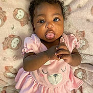 Azyla joined the competition — help win amazing prizes! baby, infant, child, pink_dress, bear_face, blanket, owl_pattern, curly_hair, tongue_out, hands_clasped, cute, playful, lying_down, soft_texture, indoors, portrait, smiling_face, adorable, young_child, cozy