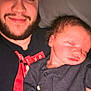 Emmett is registered to the contest to win money with this photo: man, baby, newborn, sleeping, smiling, beard, face, person, portrait, indoor, clothing, dark_blue, hand, head, closeup, cozy, family, love, parent, child