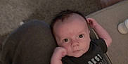 Emmett is registered to the contest to win money with this photo: baby, infant, person, clothing, toddler, carpet, toy, drool, lap, shirt, sitting, indoor, foot, floor, child, casual, relaxed, cute, family, portrait