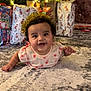 baby, carpet, celebration, cheerful, child, christmas_tree, crown, cute, decoration, festive, floor, gift_wrap, happy, holiday, indoors, infant, lights, present, smile, tinsel