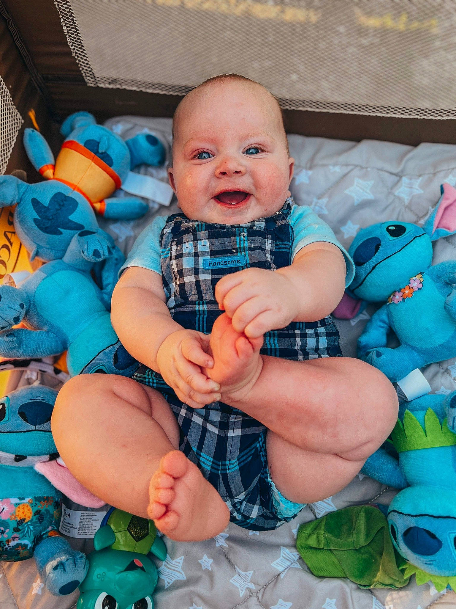 Ryder is registered to the contest to win money with this photo: baby, baby_products, baby_toddler_clothing, blue, child, comfort, electric_blue, fun, grass, green, happy, head, nail, pattern, person, purple, sitting, skin, smile, textile