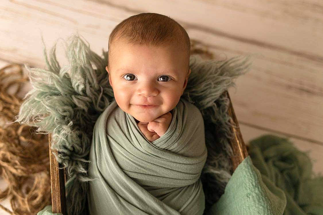 Elias is registered to the contest to win money with this photo: child, chin, eye, eyebrow, face, grass, happy, head, headgear, human_body, iris, jacket, lip, neck, people_in_nature, person, skin, smile, toddler, toy