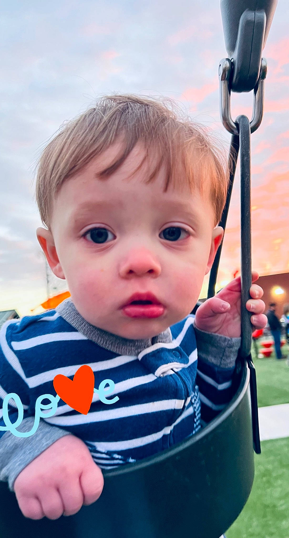 Lincoln is registered to the contest to win money with this photo: baby, baby_toddler_clothing, cheek, child, city, cloud, electric_blue, eye, facial_expression, fun, grass, happy, leisure, person, recreation, skin, sky, swing, t_shirt, toddler